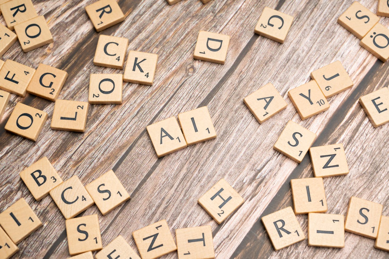 Scrabble tiles on a wooden table with the word rock