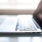 Elegant side view of a laptop on a glossy table with natural lighting indoors.